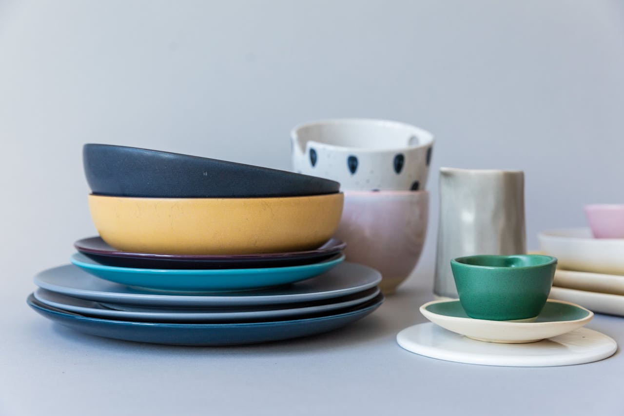A vibrant collection of modern ceramic tableware on a gray background, perfect for contemporary dining.